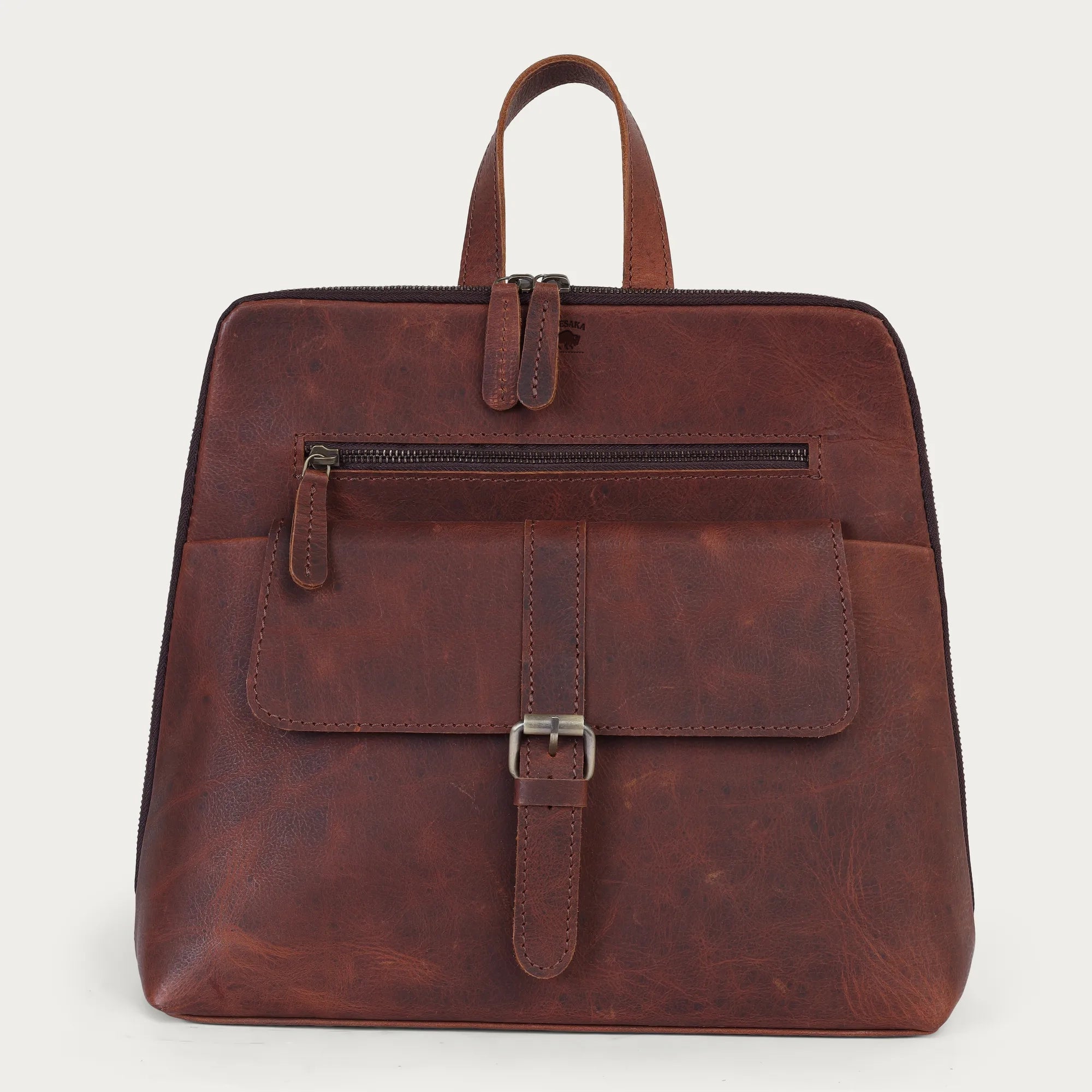Brown leather backpack on a light gray background