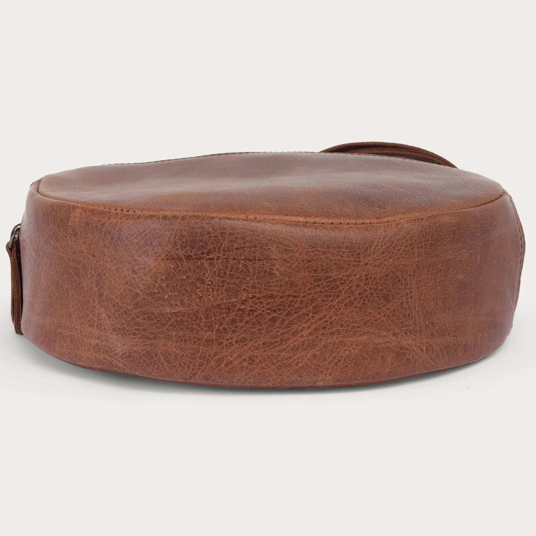 distress Brown leather bag on a light gray background