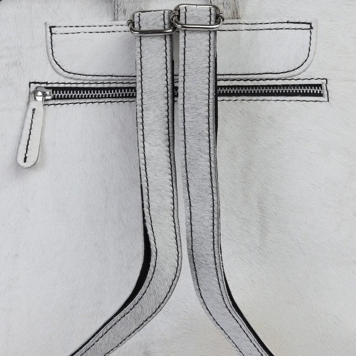 white hairon backpack with zippers on a light gray background