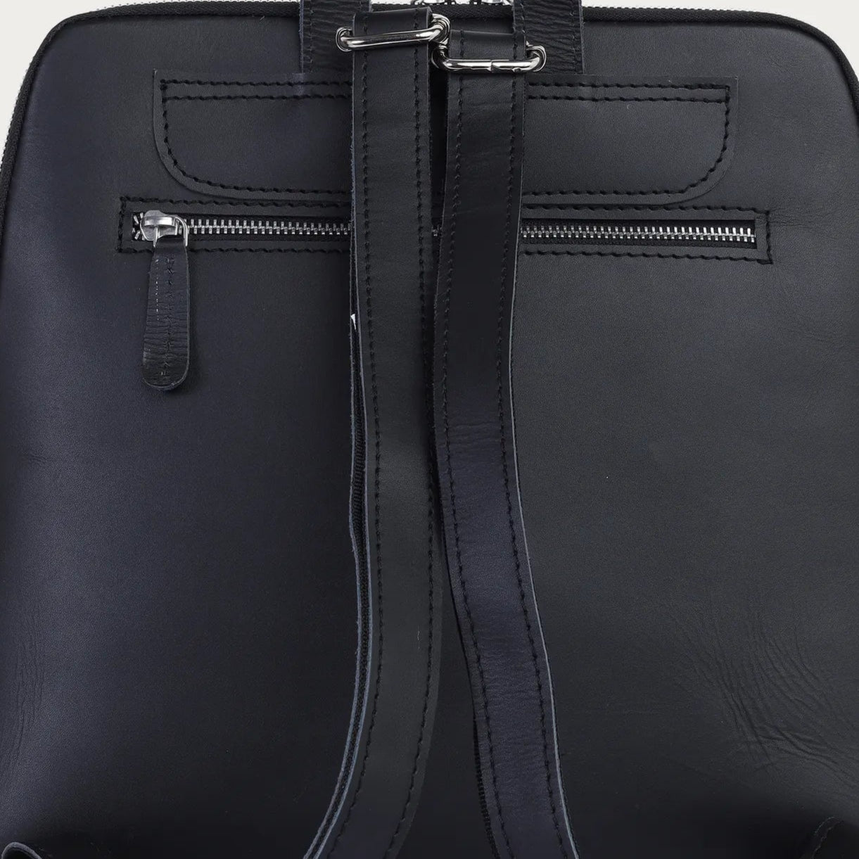 Black backpack on a light gray background