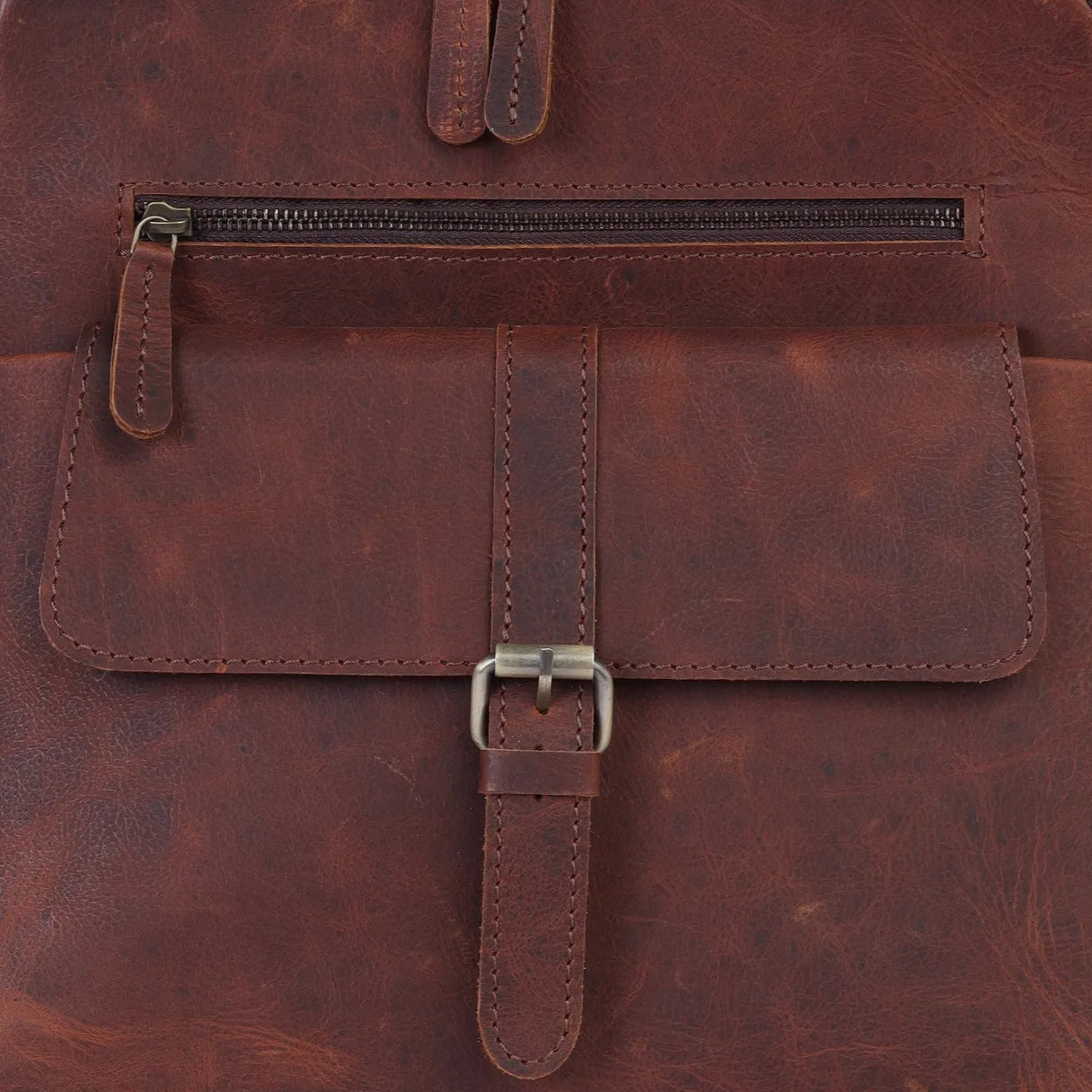 Brown leather backpack on a light gray background