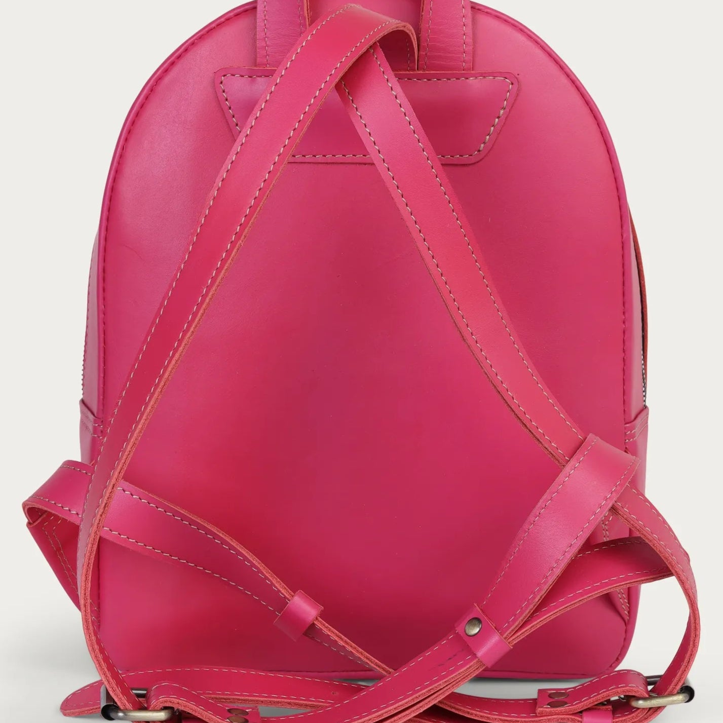 Pink backpack on a light gray background