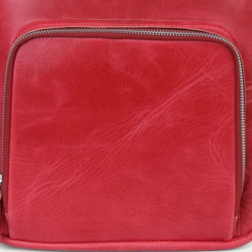 Red leather backpack on a light gray background