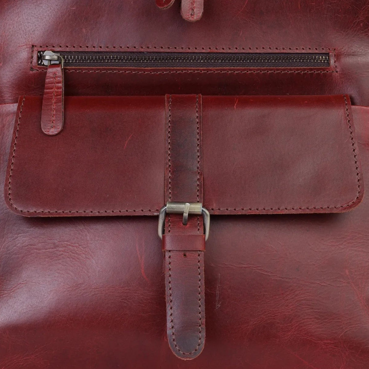 Wine leather backpack on a light gray background