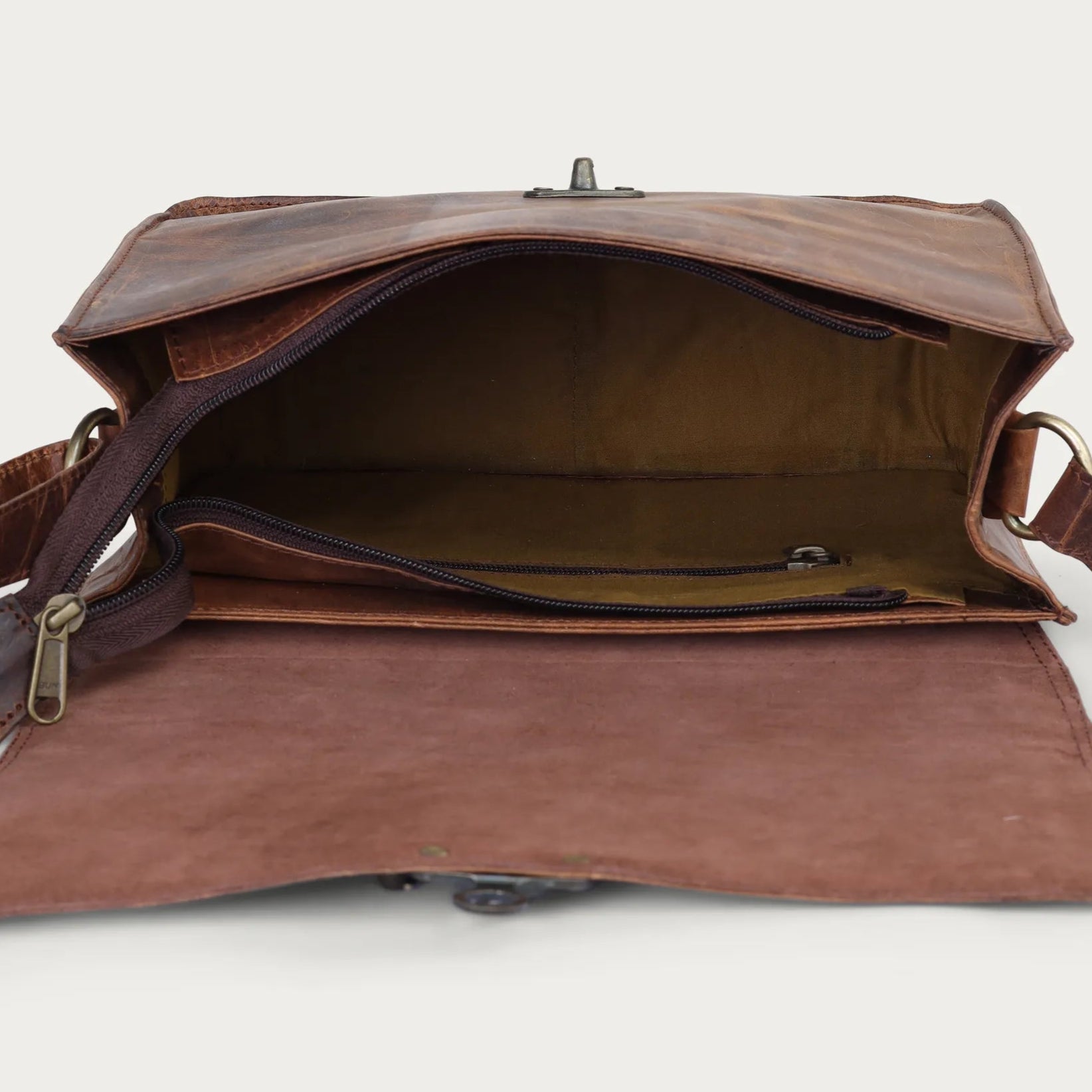 vintage Brown leather bag with a shoulder strap on a white background