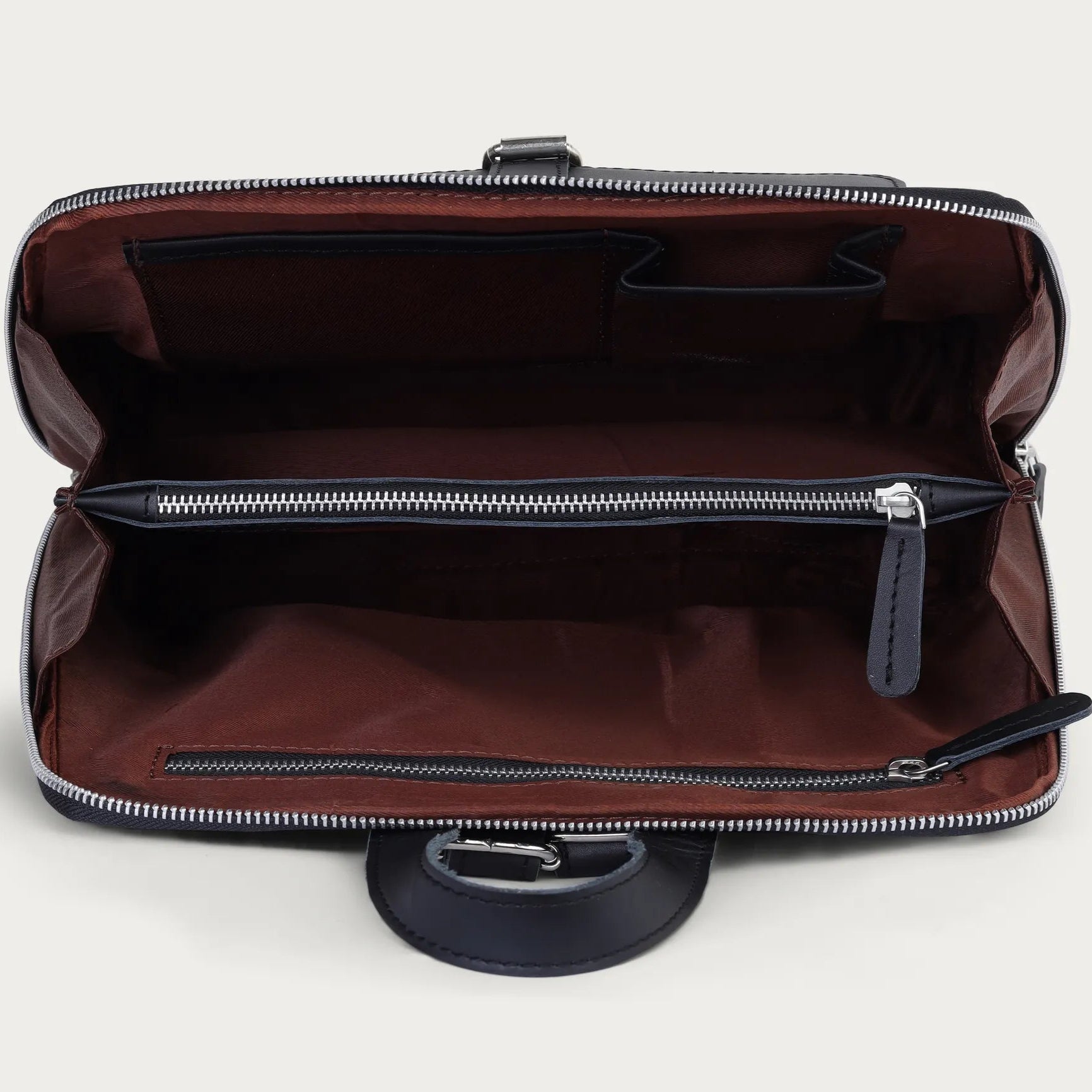 Black leather briefcase with open zipper on a light gray background
