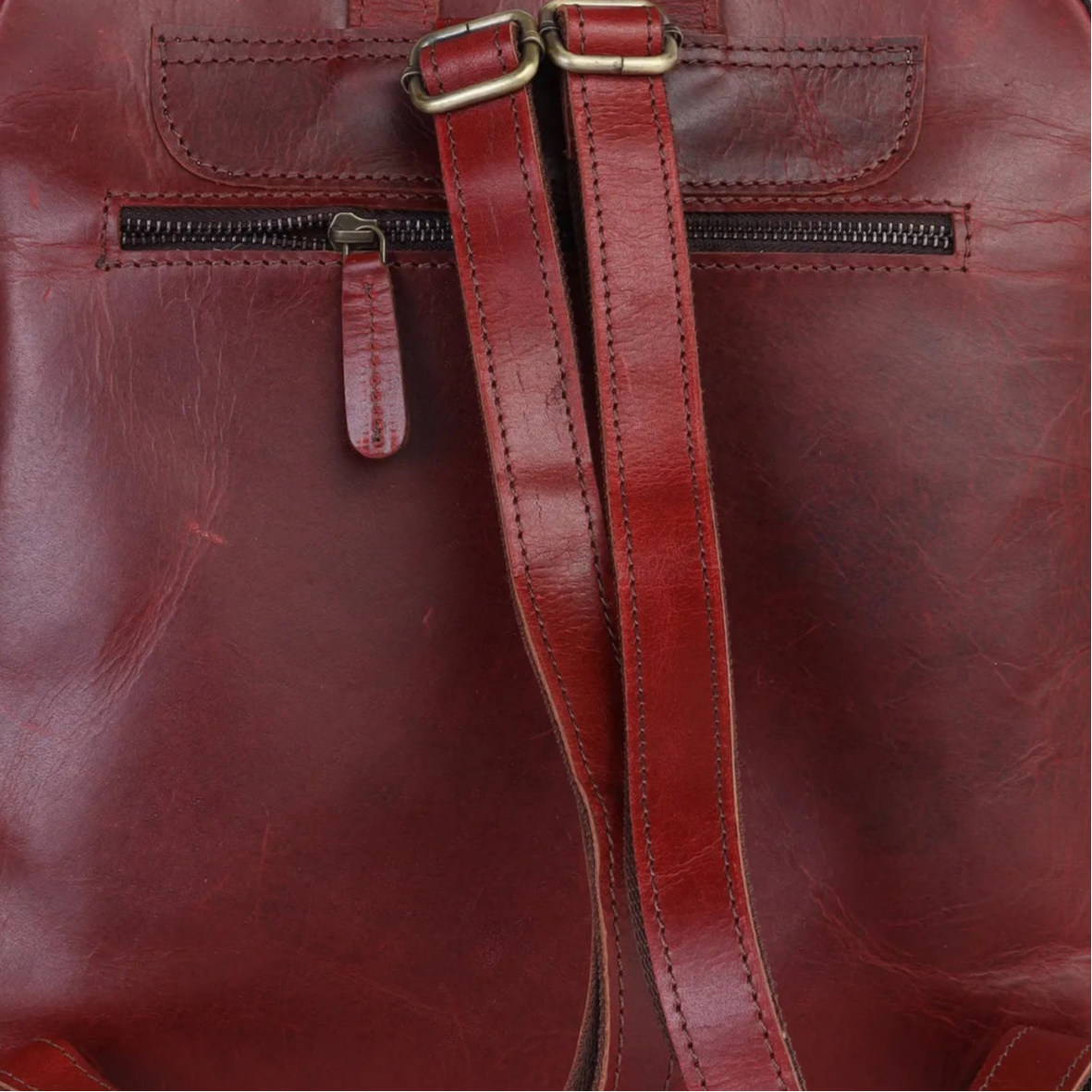 Wine leather backpack on a light gray background