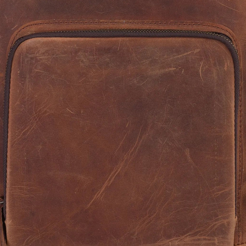 Brown leather backpack on a white background