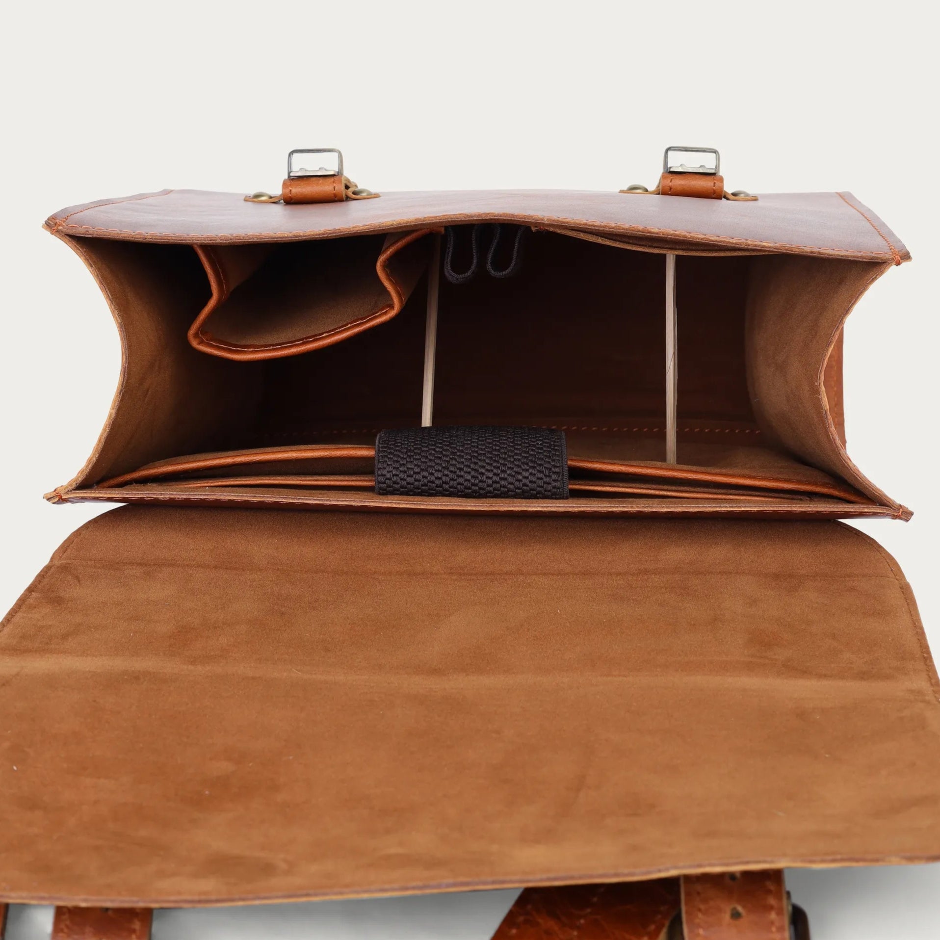 tan leather bag with open front section on a light gray background
