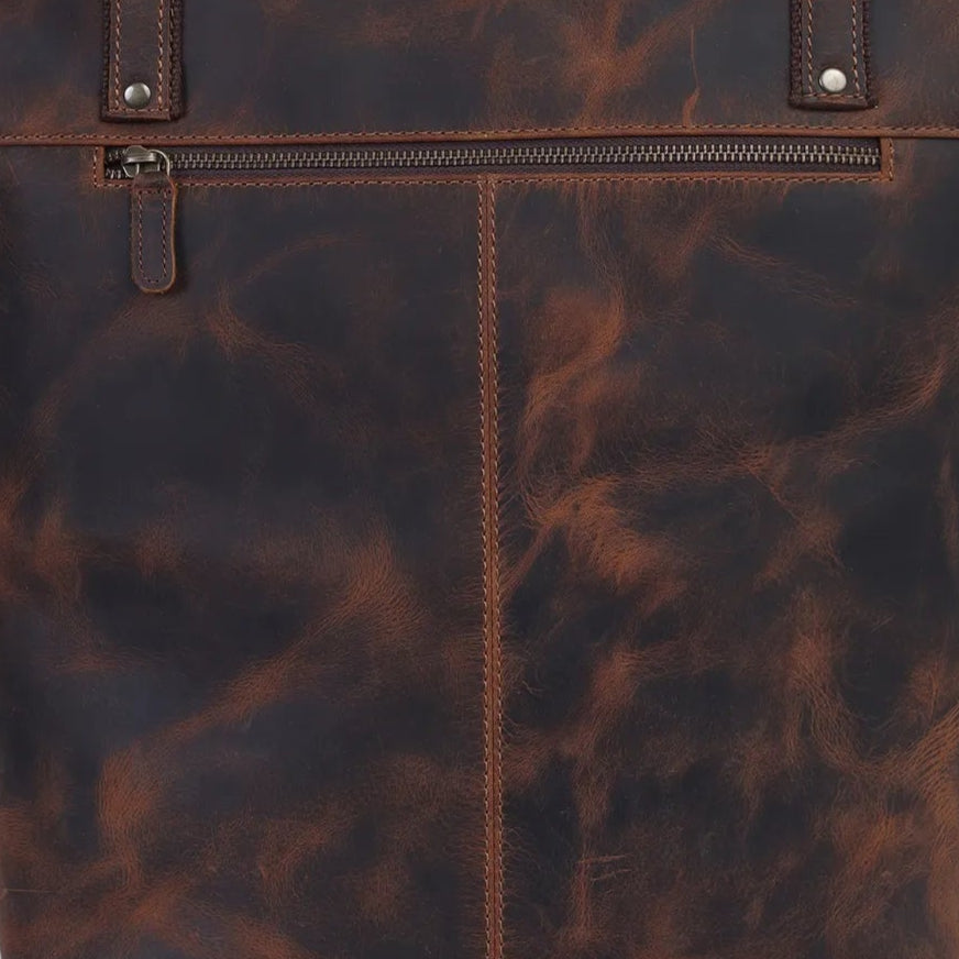 Brown leather tote bag on a light gray background