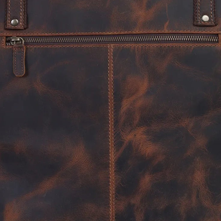 Brown leather tote bag on a light gray background