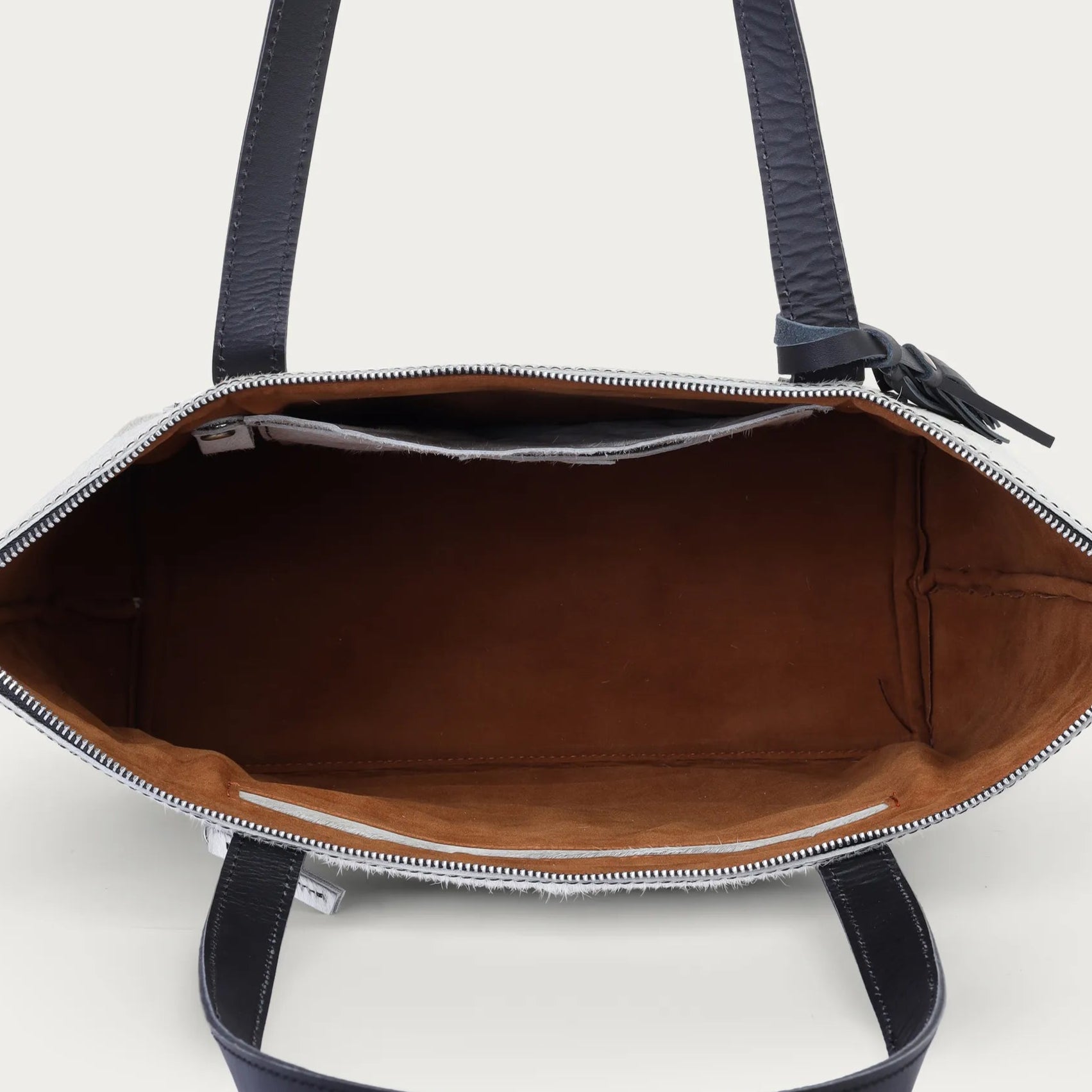 handbag with open front compartment on a white background